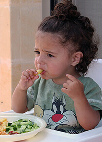 Toddler eating vegtables